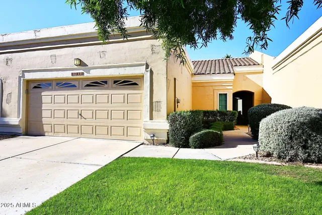 a front view of a house with a garden and plants