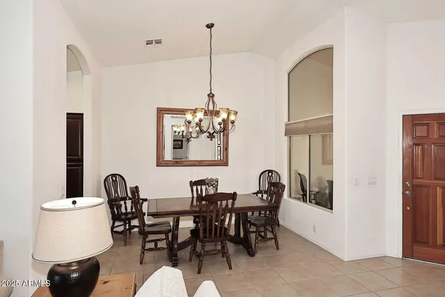 a view of a dining room with furniture and a chandelier
