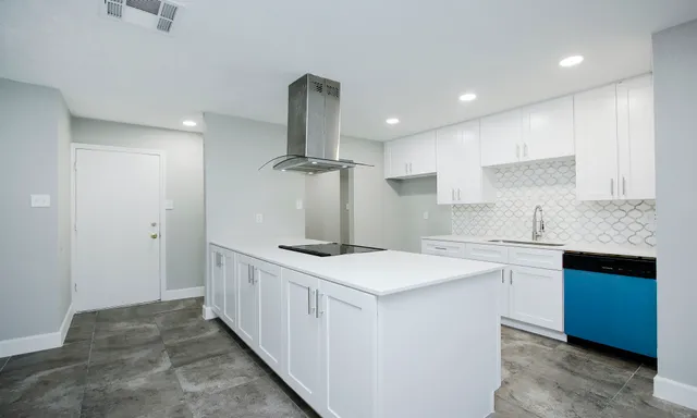 a kitchen that has a sink and a stove in it