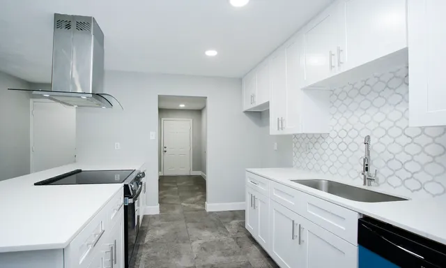 a kitchen that has a sink and a stove in it