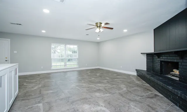 a view of an empty room with a fireplace