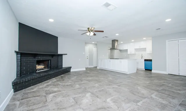a view of an empty room with a fireplace