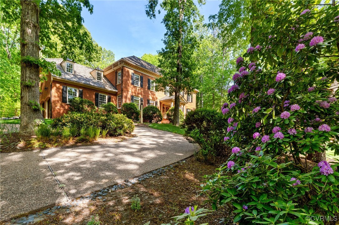 3831 Reeds Landing Circle Midlothian, VA 23113 - Photo 2 of 50 a view of a white house with a flower garden
