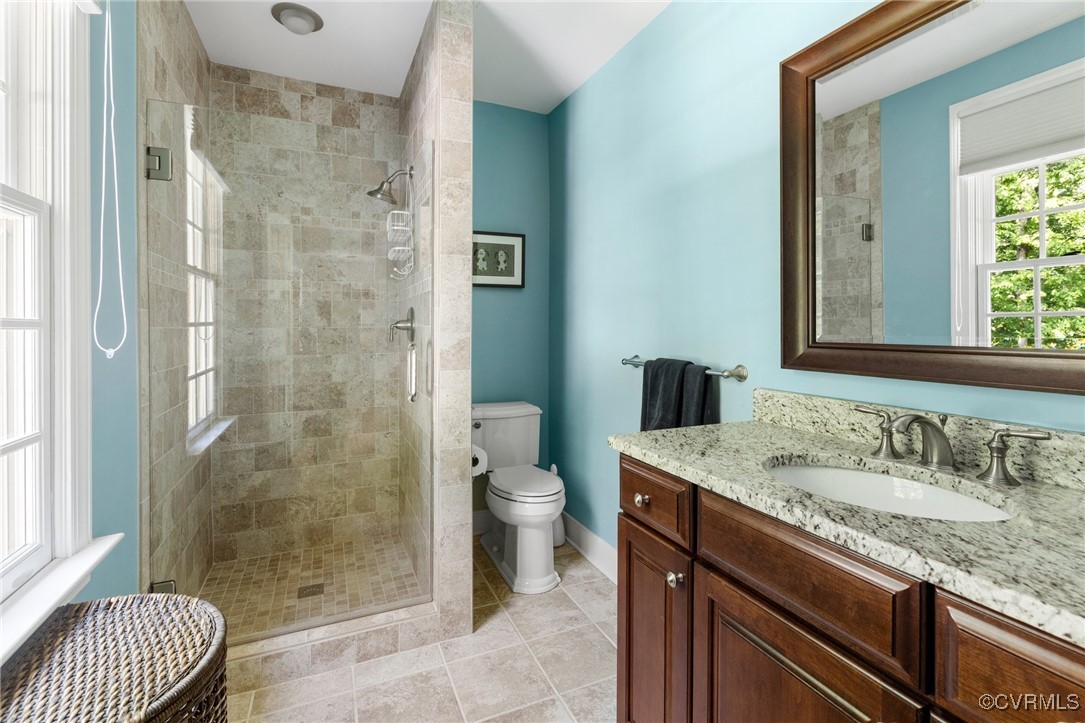 3831 Reeds Landing Circle Midlothian, VA 23113 - Photo 28 of 50 a bathroom with a granite countertop sink a toilet a mirror and shower