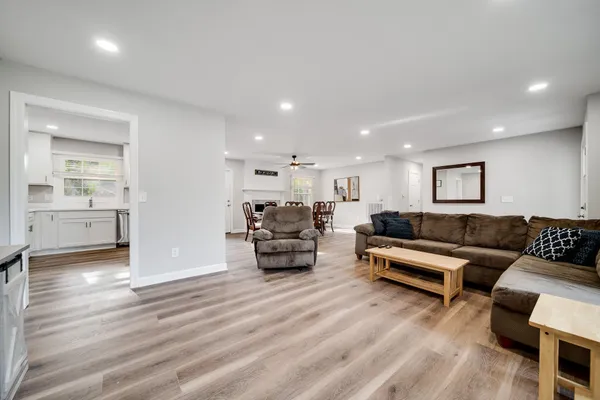 a living room with furniture and wooden floor