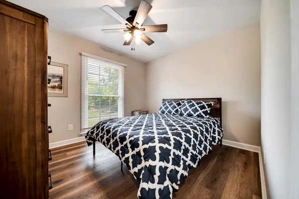 a bedroom with a bed and a chandelier