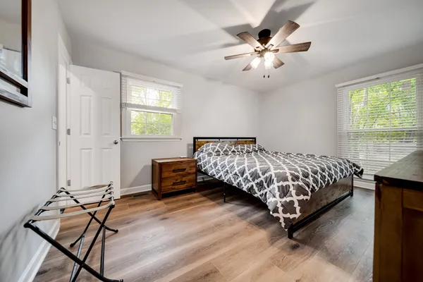 a bedroom with a bed and a chandelier