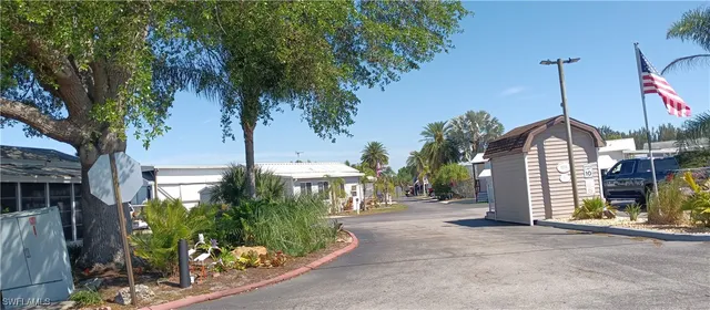 a view of a house with a tree and a yard