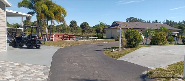 a view of a street with a cars parked in front of it