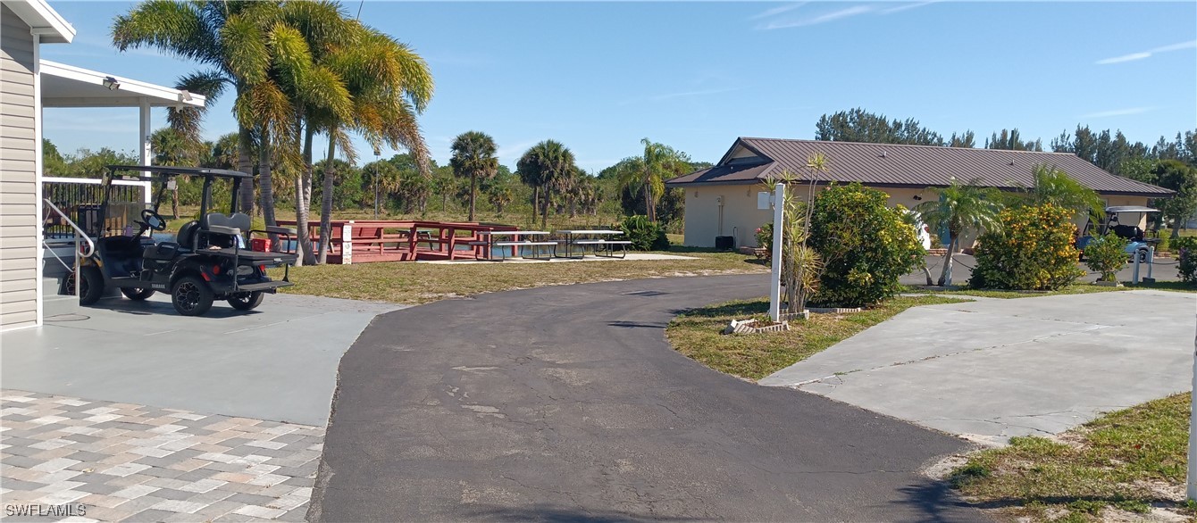 1159 Daniels Road Moore Haven, FL 33471 - Photo 3 of 21 a view of a street with a cars parked in front of it