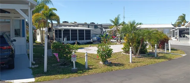 a view of a backyard house and tree s