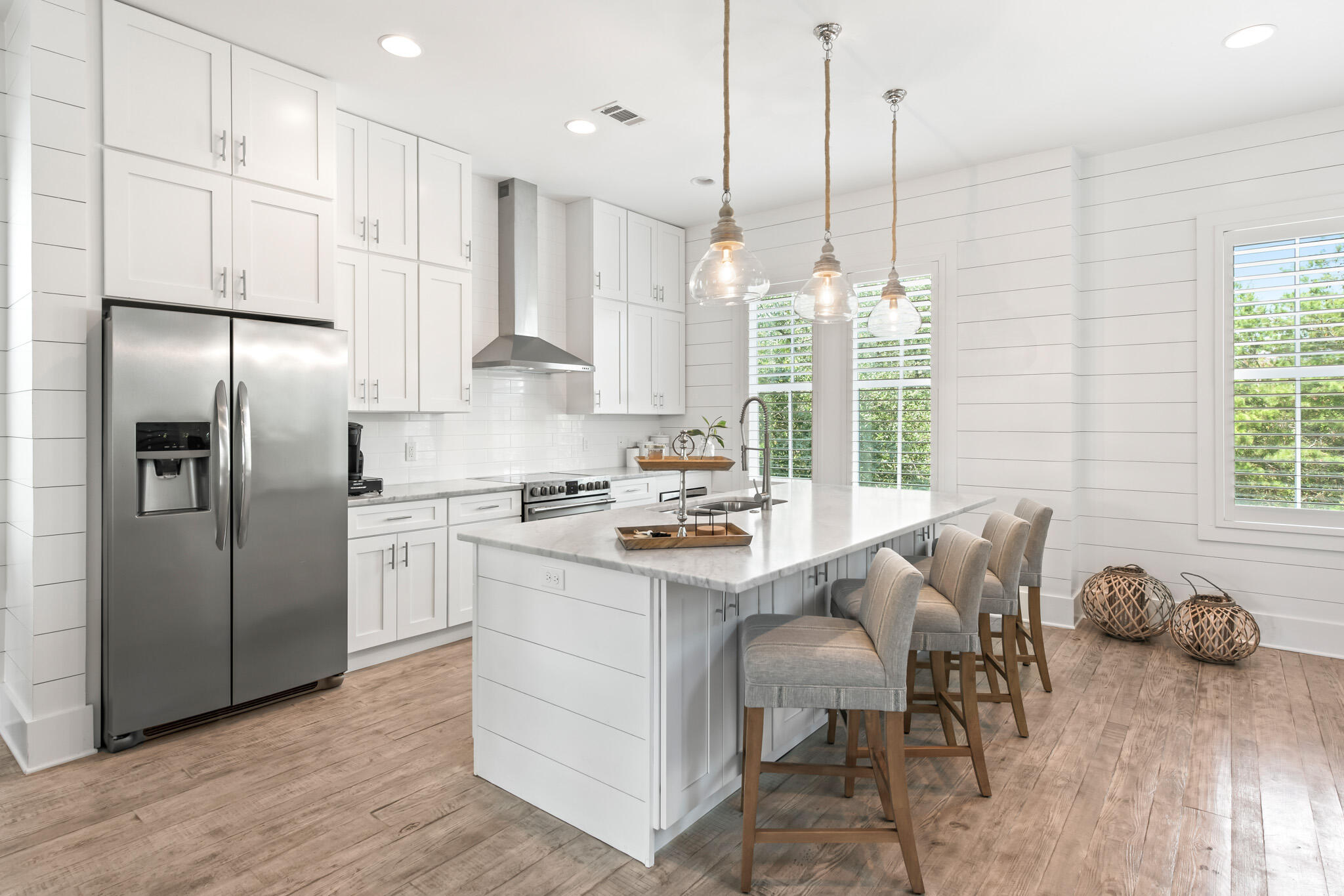 11 Pompano Pl Inlet Beach Inlet Beach, FL 32461 - Photo 25 of 68 a kitchen with stainless steel appliances granite countertop a refrigerator a sink dishwasher a stove and white cabinets with wooden floor