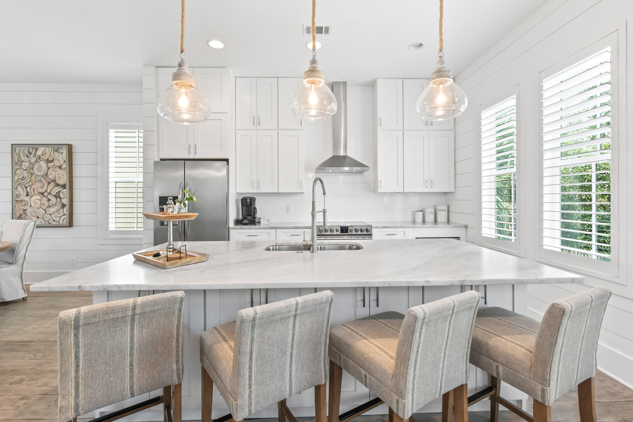 11 Pompano Pl Inlet Beach Inlet Beach, FL 32461 - Photo 26 of 68 a kitchen with kitchen island granite countertop a sink a center island a stove cabinets and a dining table
