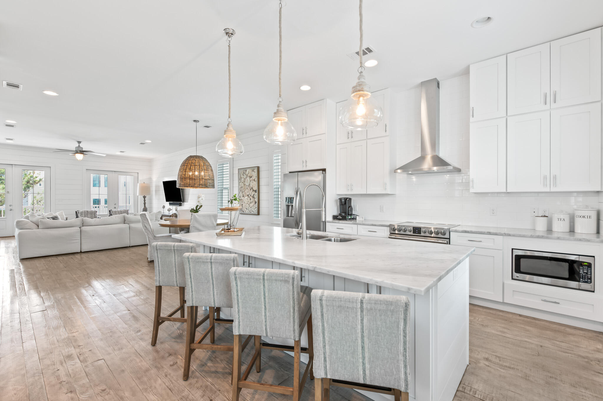 11 Pompano Pl Inlet Beach Inlet Beach, FL 32461 - Photo 29 of 68 a kitchen with kitchen island granite countertop a sink a stove a dining table and chairs