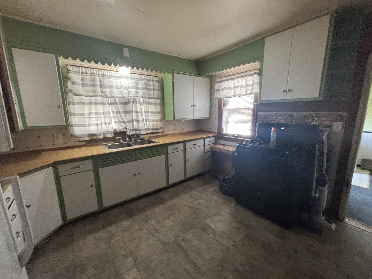 403 South Fall Street Paxton, IL 60957 - Photo 13 of 13 a kitchen with granite countertop white cabinets and sink