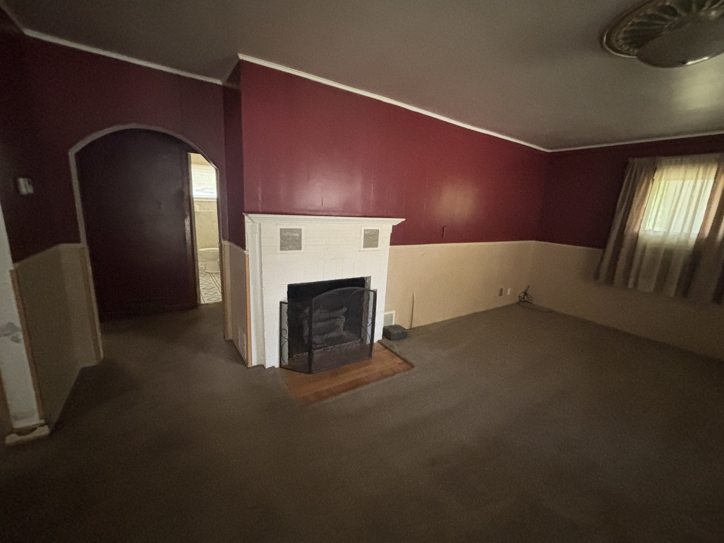 403 South Fall Street Paxton, IL 60957 - Photo 5 of 13 a view of empty room with fireplace and window