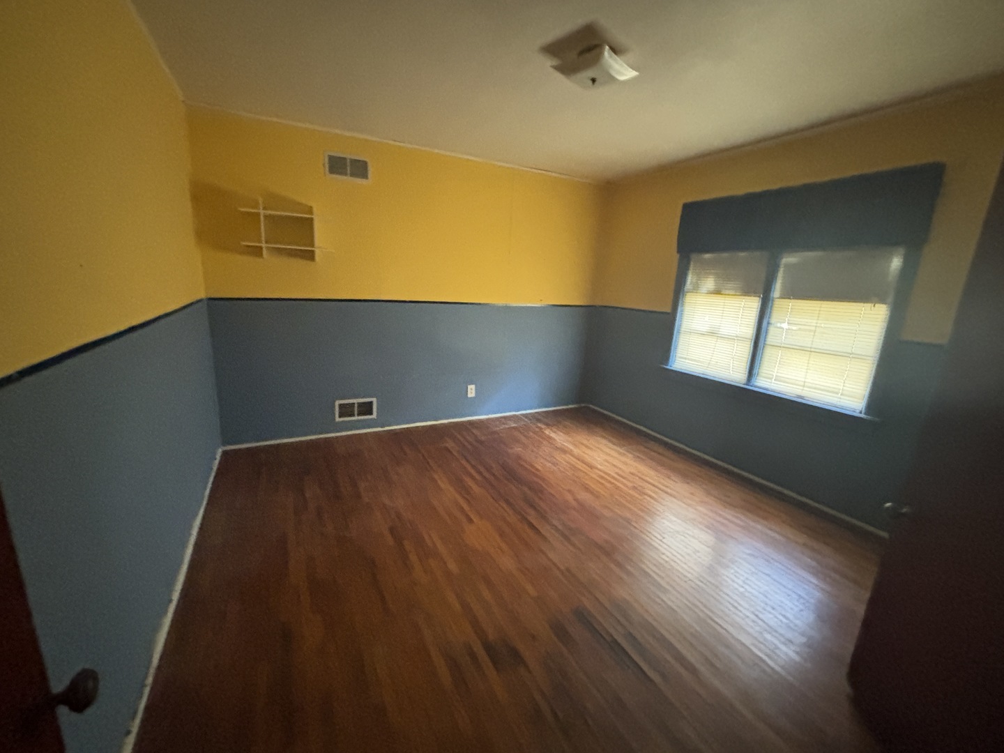 403 South Fall Street Paxton, IL 60957 - Photo 7 of 13 a view of an empty room with wooden floor and a window
