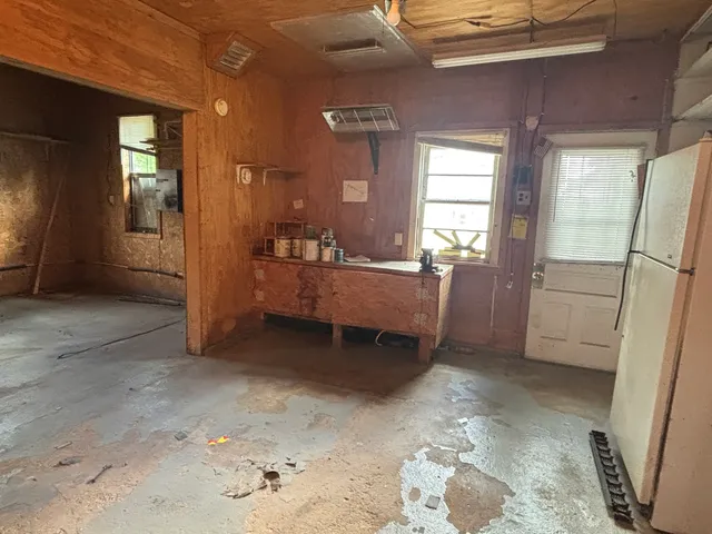 a bathroom with a sink a toilet a window and shower