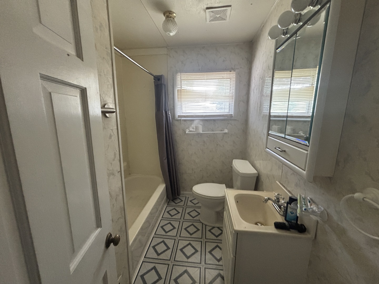 403 South Fall Street Paxton, IL 60957 - Photo 10 of 13 a bathroom with a sink a toilet a window and shower