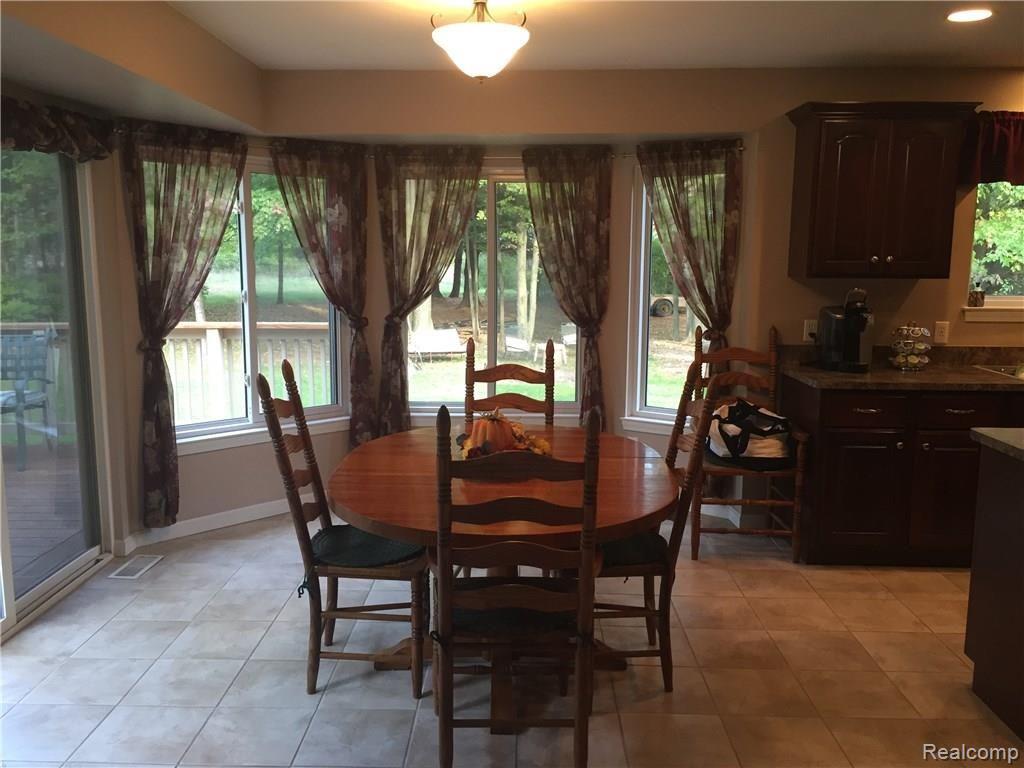 21325 24 Mile Road Macomb, MI 48042 - Photo 3 of 38 Breakfast nook, kitchen to the right and back patio to the left.
