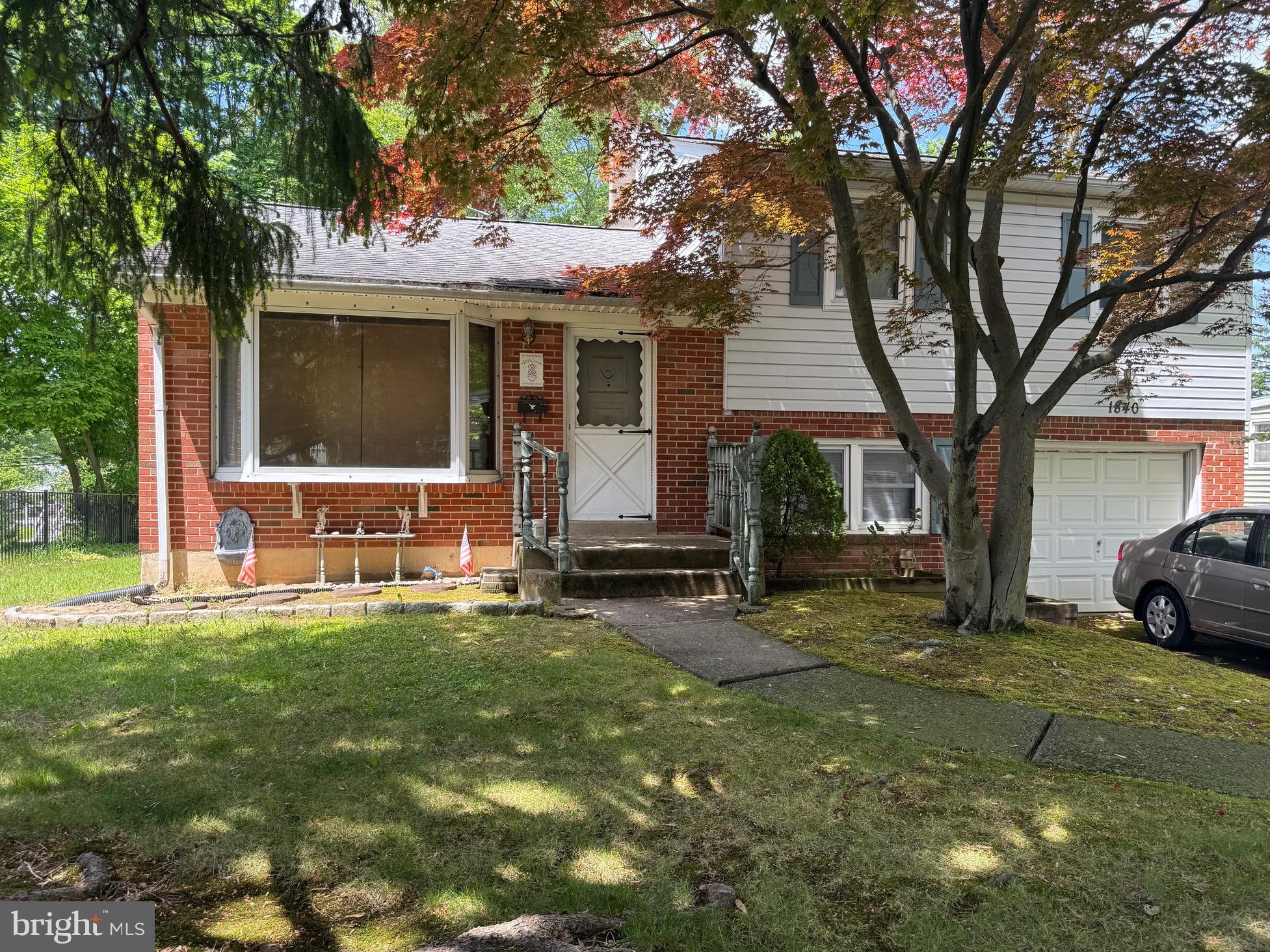 a view of a house with backyard and a tree