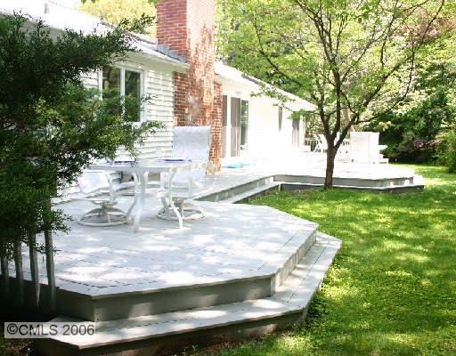 2216 High Ridge Road Stamford, CT 06903 - Photo 1 of 1 a view of a backyard with table and chairs and potted plants