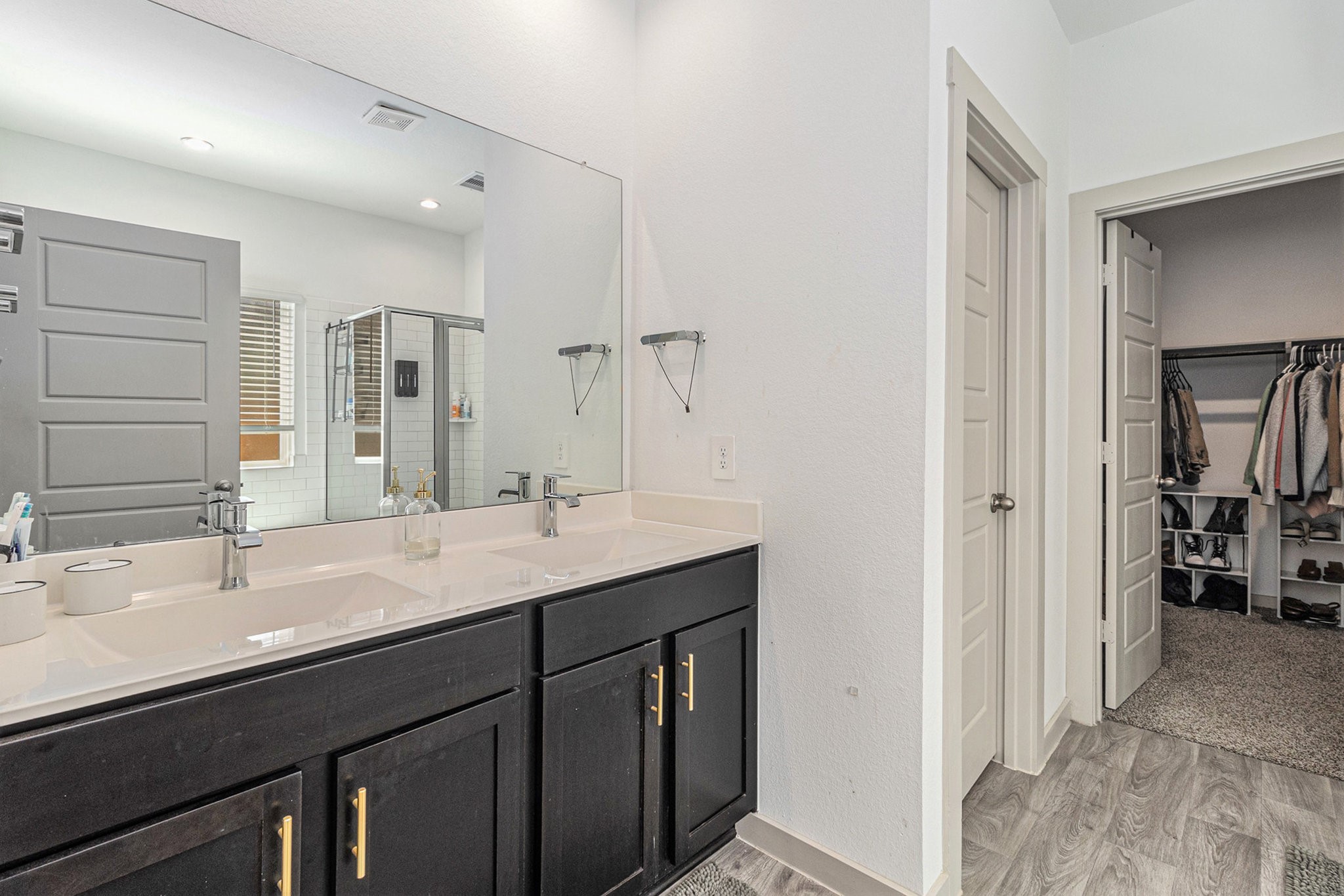 12823 Tokenhouse Lane Houston, TX 77047 - Photo 19 of 37 a bathroom with a double vanity sink a and mirror