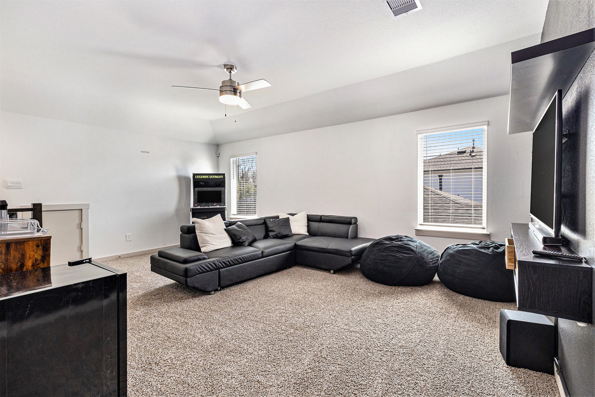 12823 Tokenhouse Lane Houston, TX 77047 - Photo 21 of 37 a living room with furniture a ceiling fan and a flat screen tv