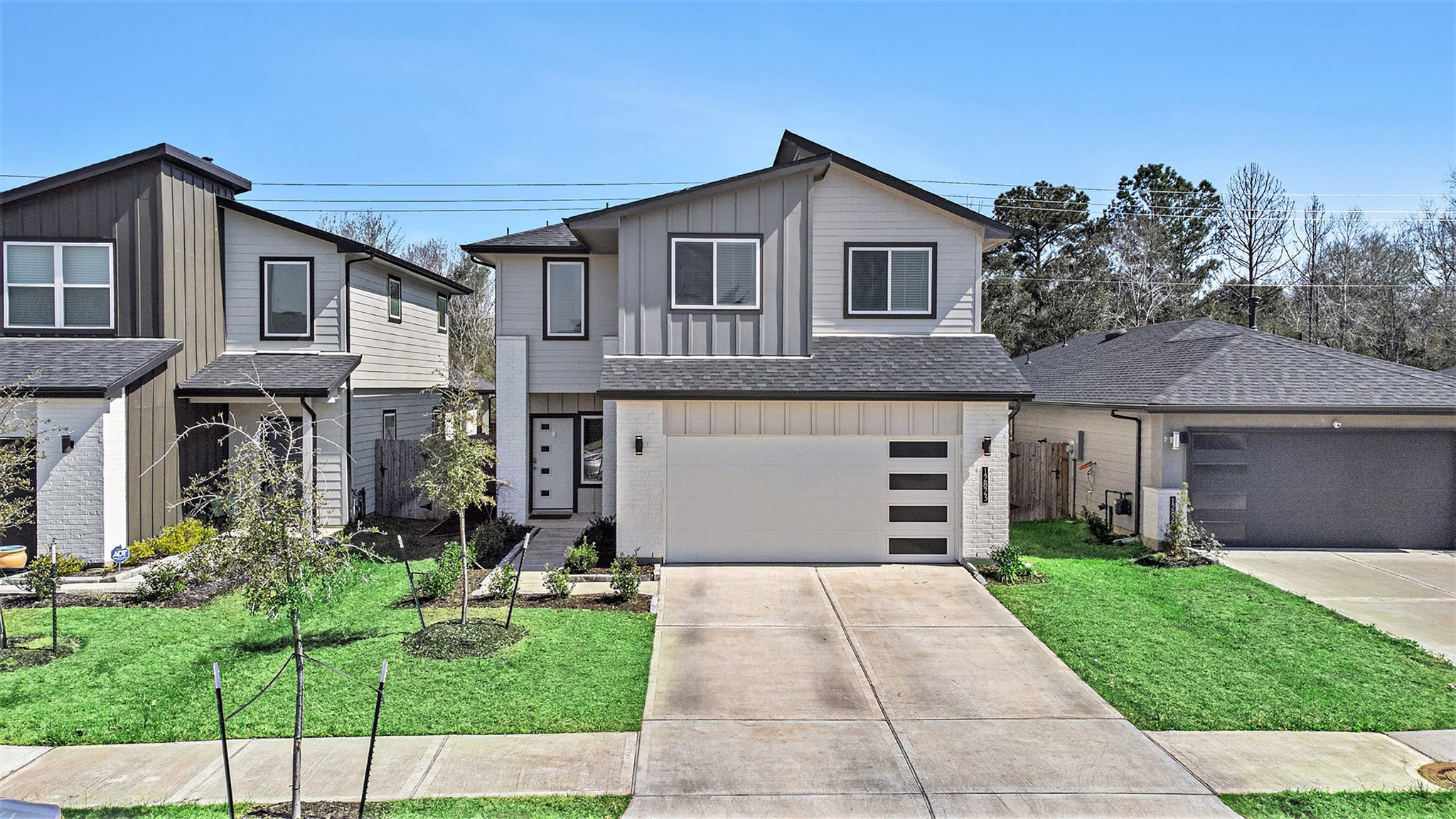 12823 Tokenhouse Lane Houston, TX 77047 - Photo 5 of 37 a front view of a house with a yard and potted plants
