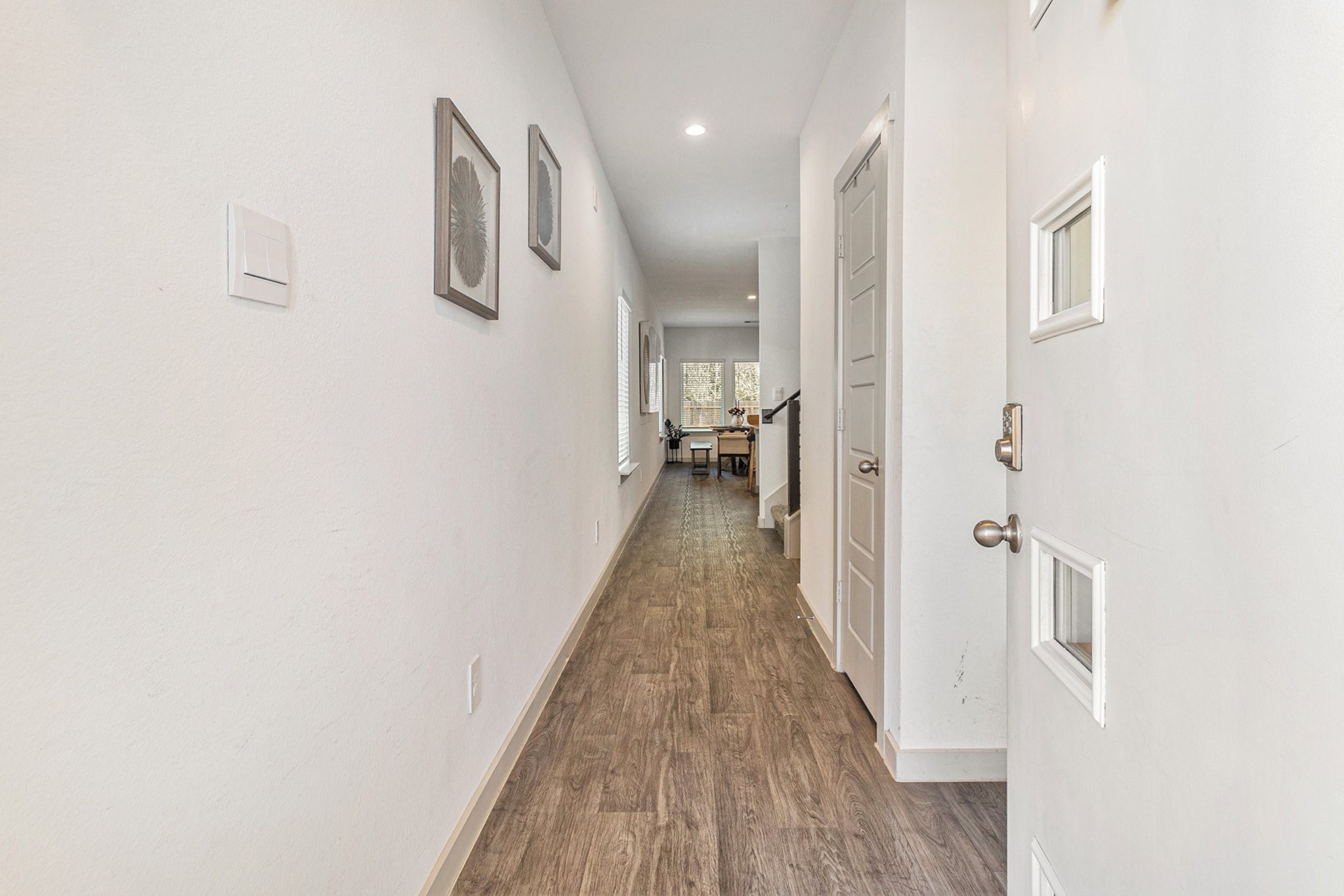 12823 Tokenhouse Lane Houston, TX 77047 - Photo 6 of 37 a view of a hallway with wooden floor and staircase