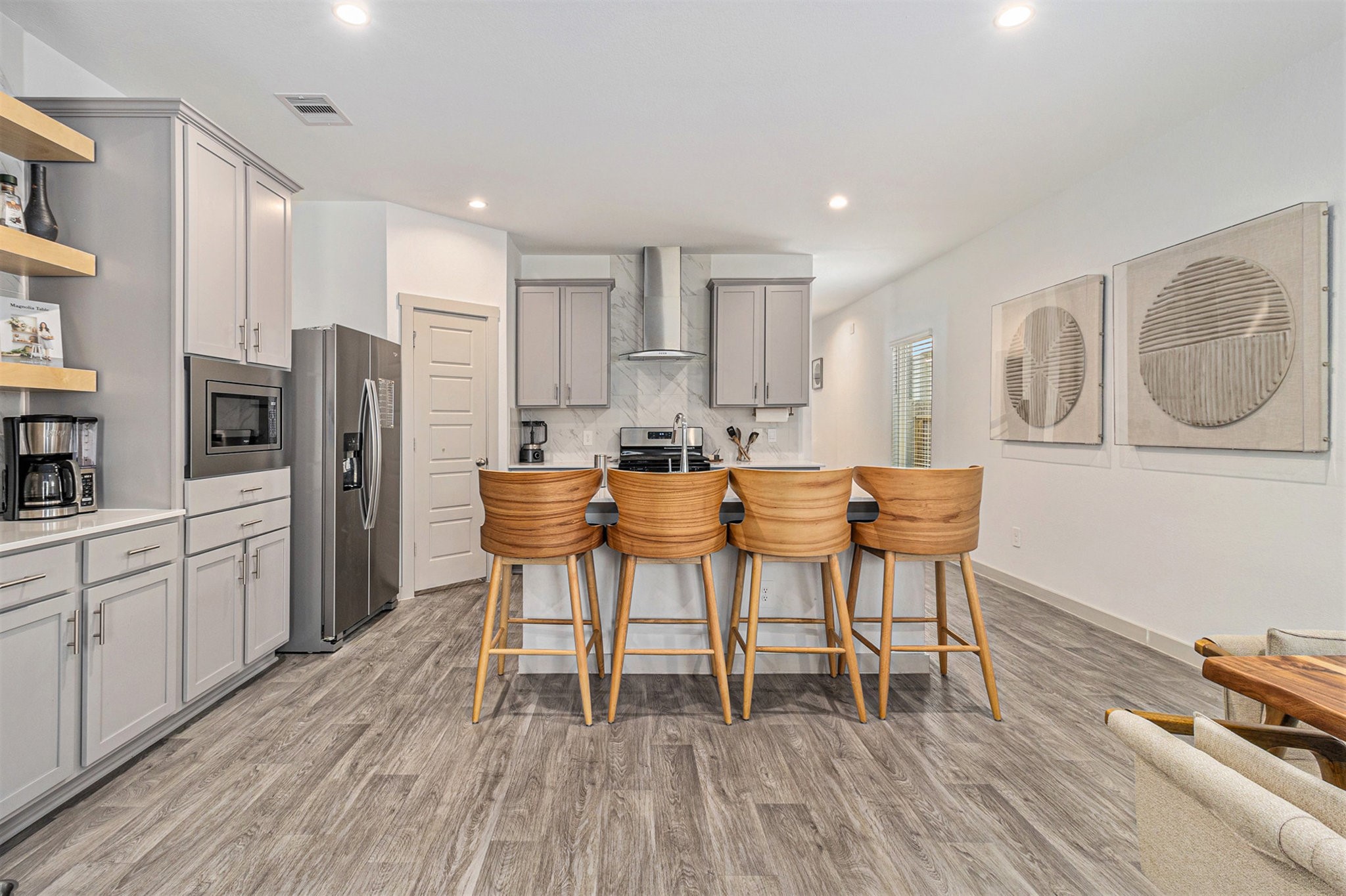 12823 Tokenhouse Lane Houston, TX 77047 - Photo 9 of 37 a kitchen with stainless steel appliances a dining table chairs stove refrigerator and cabinets
