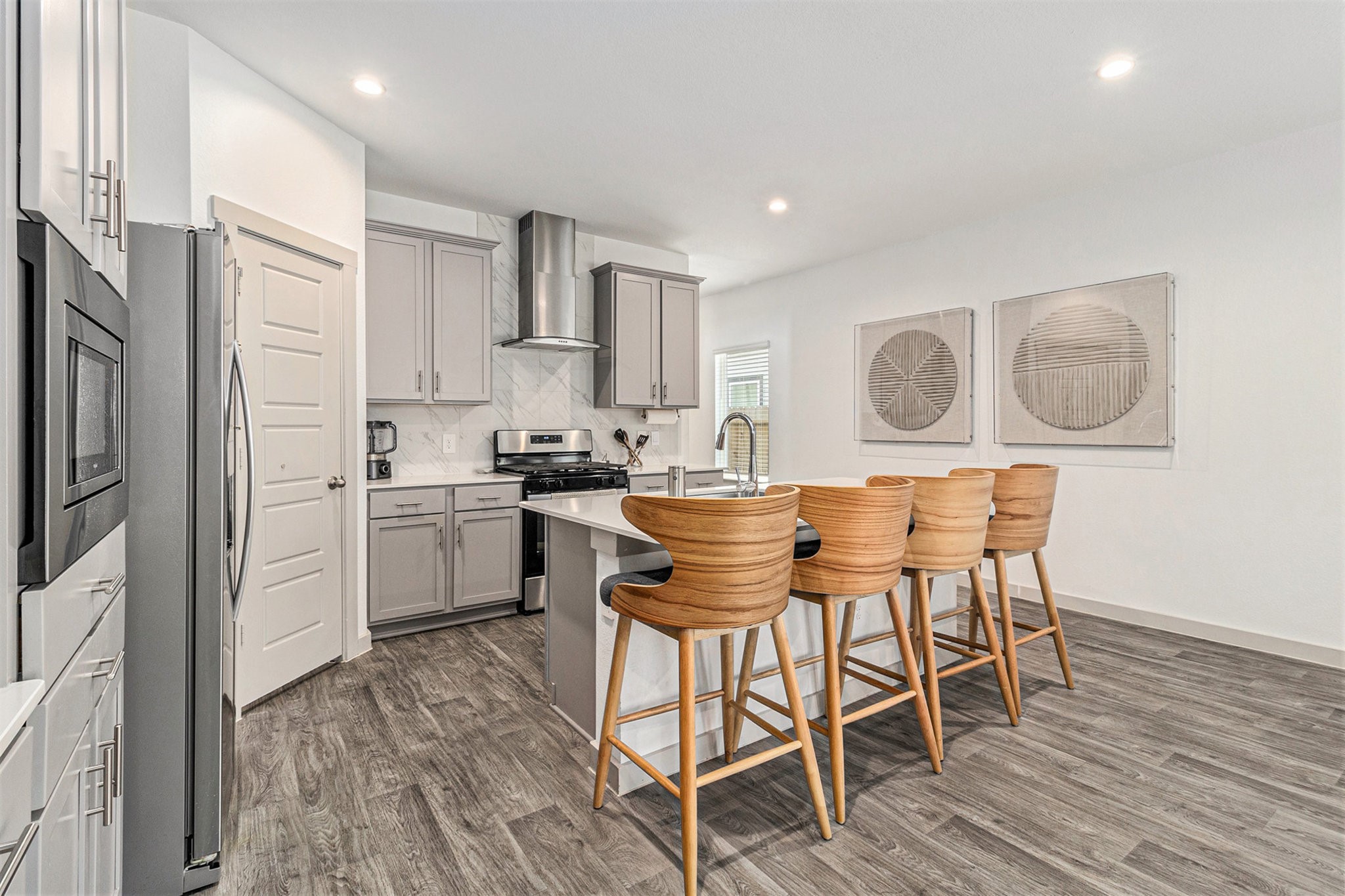 12823 Tokenhouse Lane Houston, TX 77047 - Photo 10 of 37 a kitchen with stainless steel appliances kitchen island granite countertop a dining table chairs and sink