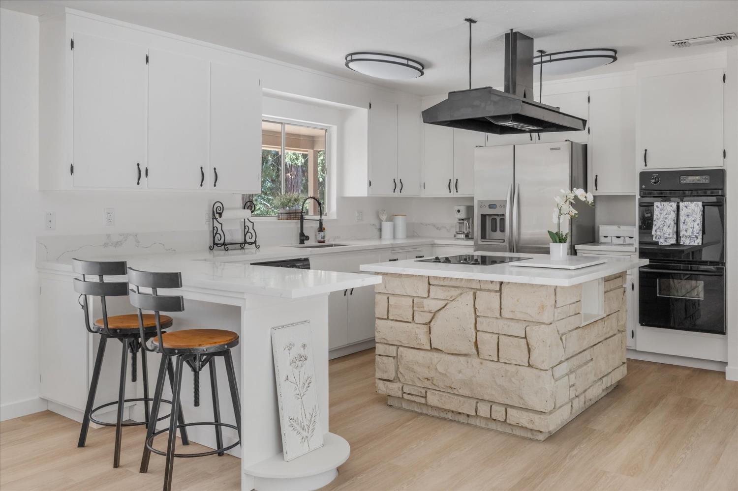 a kitchen with stainless steel appliances a white cabinets and a stove