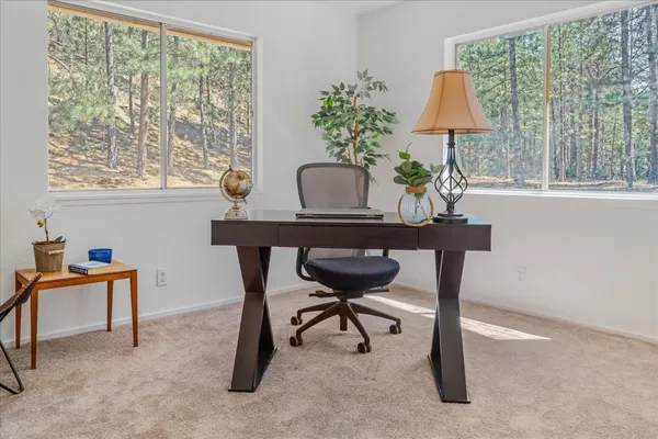 a wooden house with large trees and outdoor space