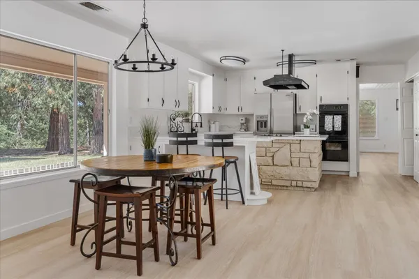 a view of a dining room with furniture window and wooden floor