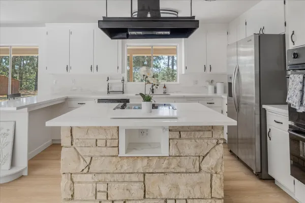 a kitchen with a sink a refrigerator and a stove