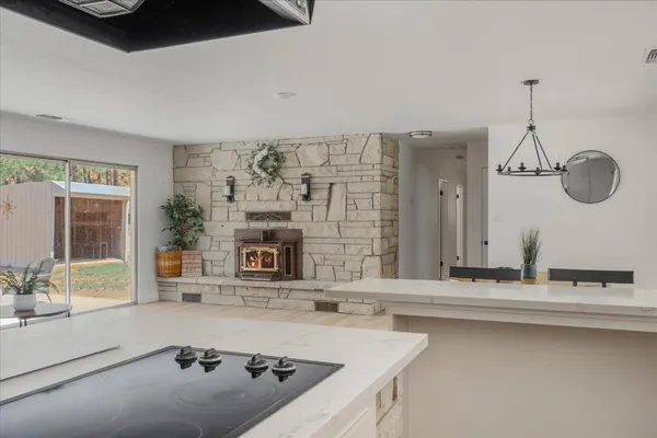 a dining room with furniture a chandelier and wooden floor