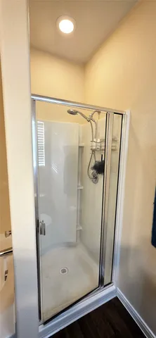 a bathroom with a glass shower door