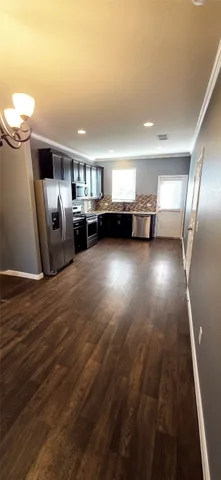 a view of a livingroom with furniture wooden floor and windows