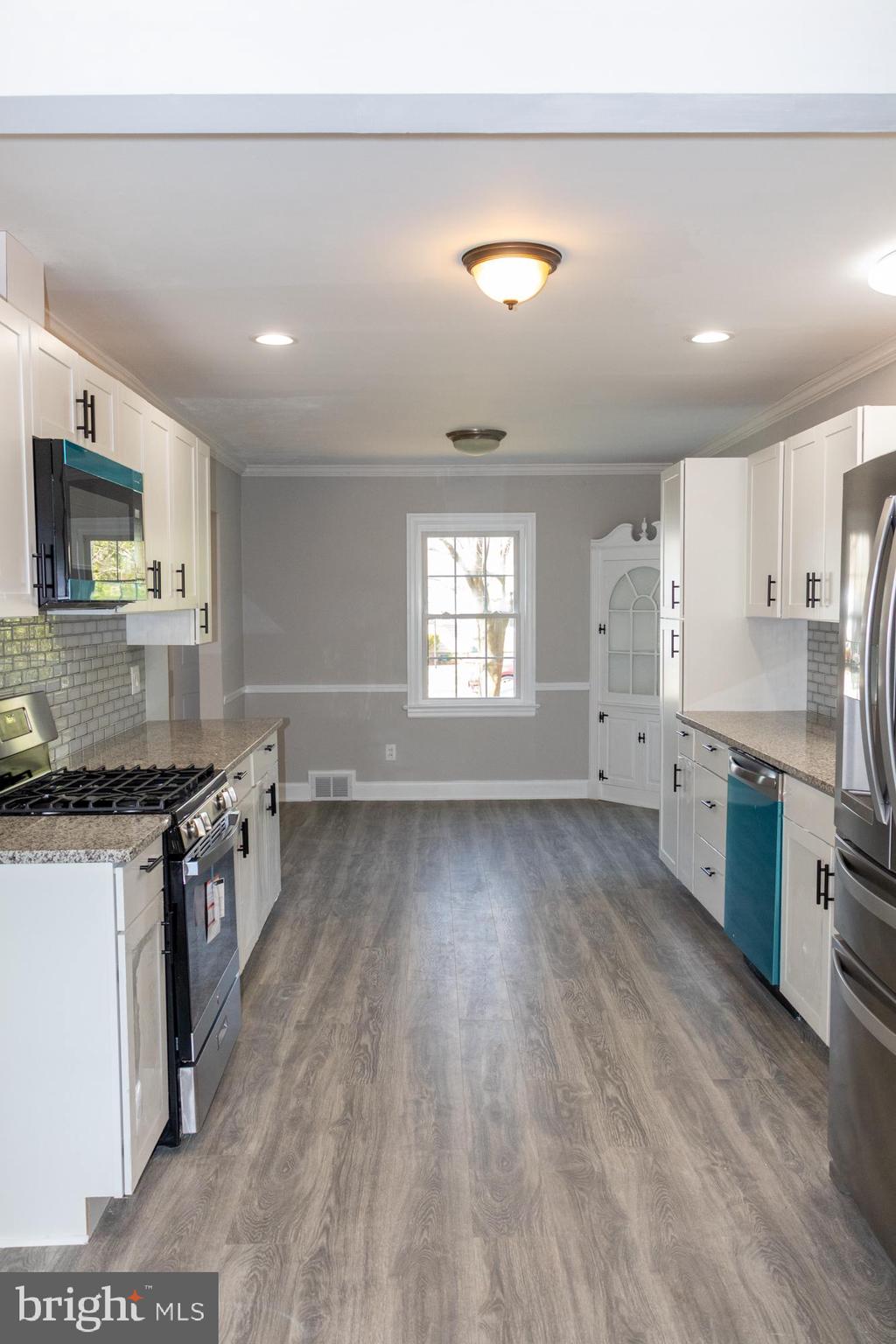 26 Byron Avenue Hamilton, NJ 08610 - Photo 12 of 33 a kitchen with stainless steel appliances granite countertop a stove a sink and a refrigerator