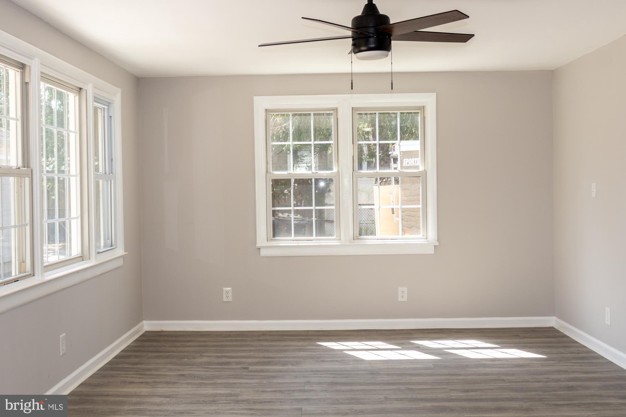 26 Byron Avenue Hamilton, NJ 08610 - Photo 19 of 33 a view of an empty room with wooden floor and windows