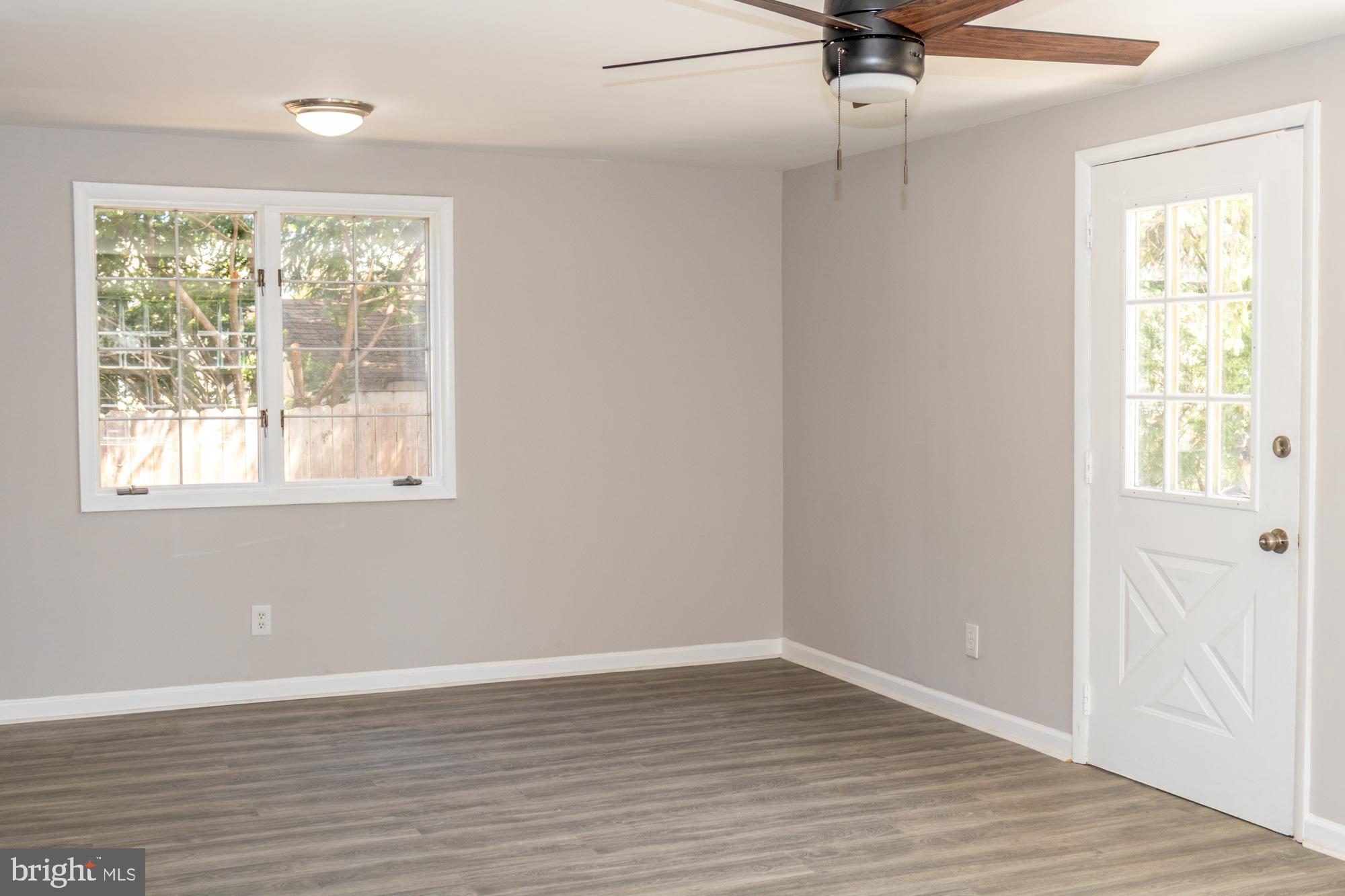 26 Byron Avenue Hamilton, NJ 08610 - Photo 20 of 33 an empty room with wooden floor fan and windows