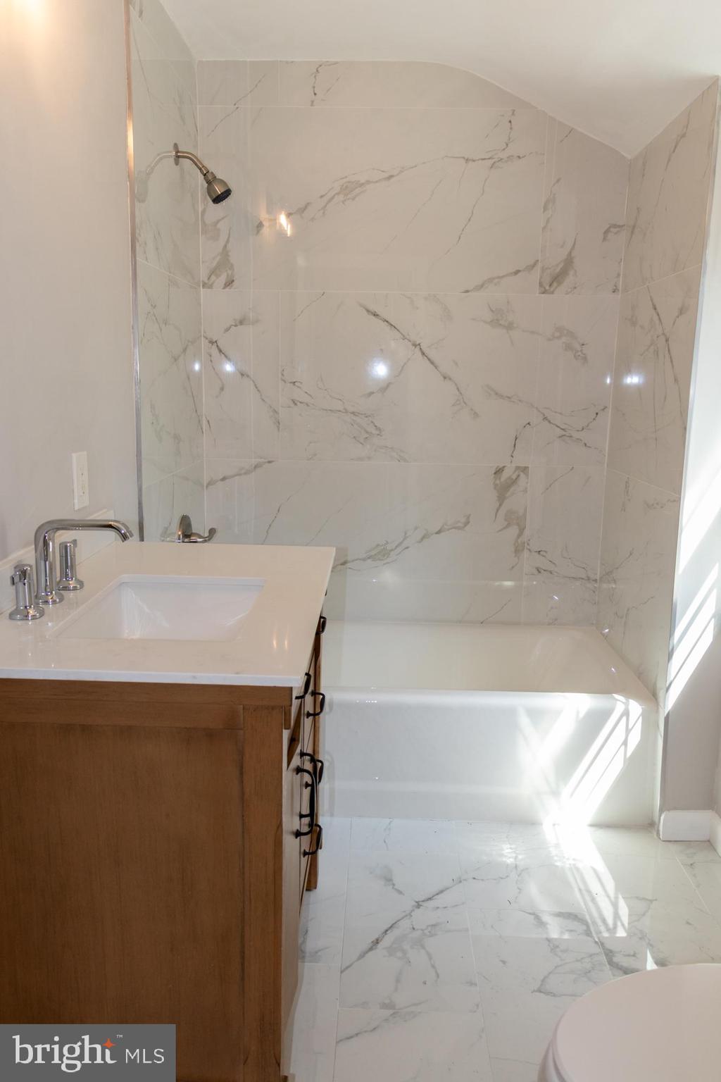 26 Byron Avenue Hamilton, NJ 08610 - Photo 30 of 33 a bathroom with a sink and a bathtub