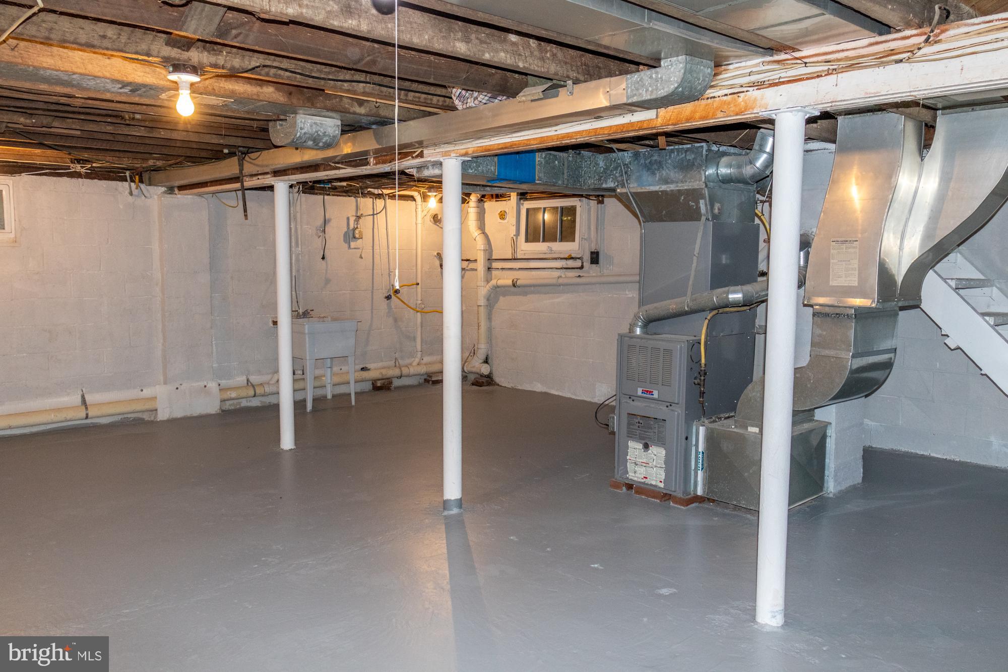 26 Byron Avenue Hamilton, NJ 08610 - Photo 32 of 33 a view of a storage room with water heater and racks