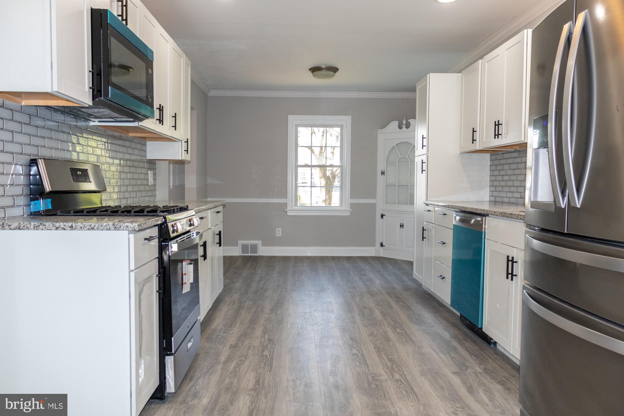 26 Byron Avenue Hamilton, NJ 08610 - Photo 8 of 33 a kitchen with stainless steel appliances a refrigerator a sink a stove top oven a counter space and cabinets