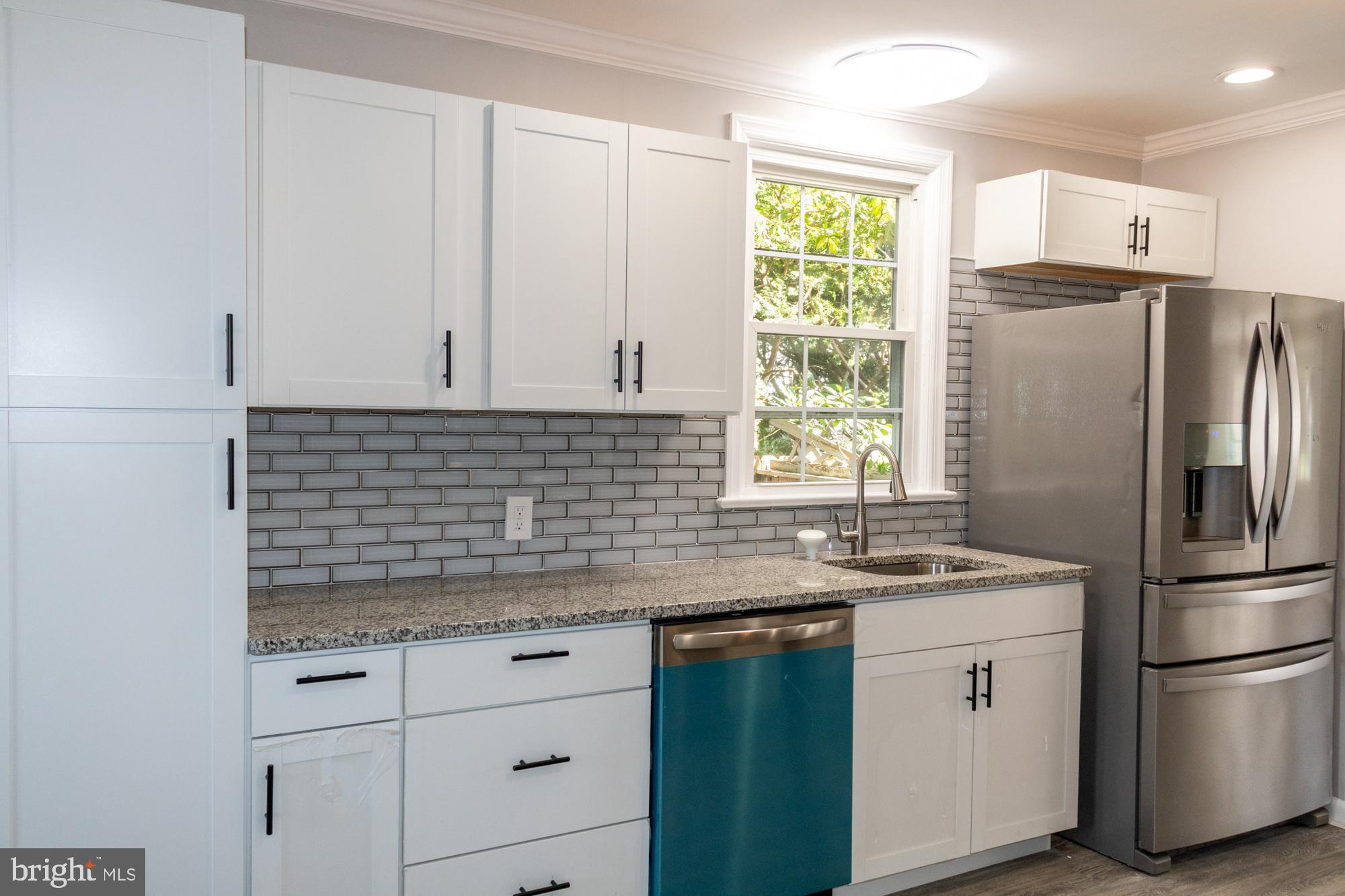 26 Byron Avenue Hamilton, NJ 08610 - Photo 10 of 33 a kitchen with granite countertop white cabinets white appliances a sink and a window