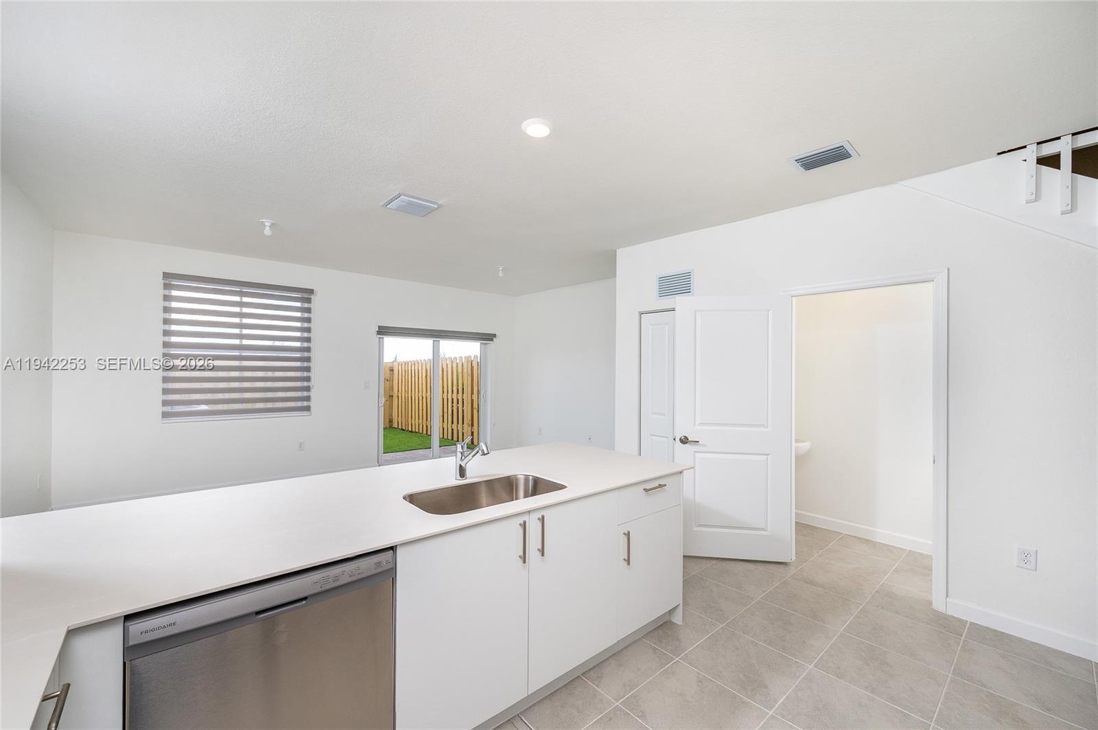 2747 Southeast 26th Road, Unit 2747 Homestead, FL 33035 - Photo 11 of 27 a room with white cabinets and sink