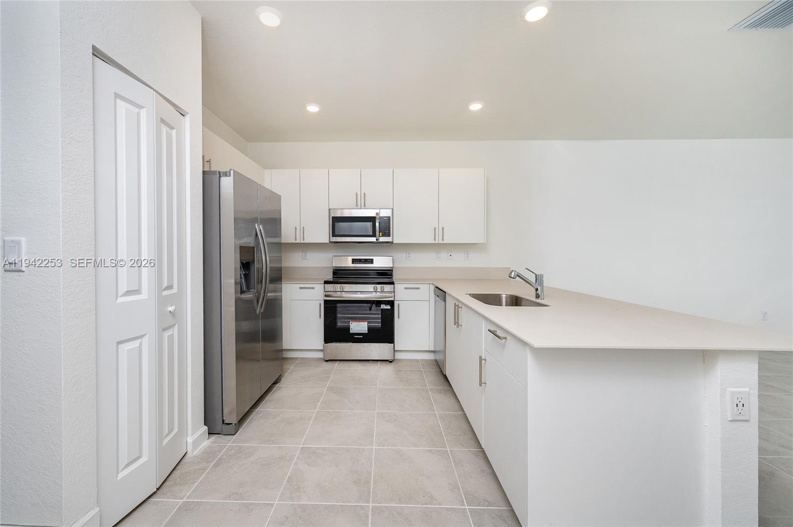 2747 Southeast 26th Road, Unit 2747 Homestead, FL 33035 - Photo 12 of 27 a view of a kitchen with electric appliances