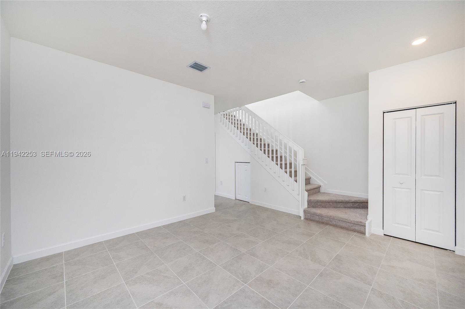 2747 Southeast 26th Road, Unit 2747 Homestead, FL 33035 - Photo 13 of 27 a view of an empty room with stairs