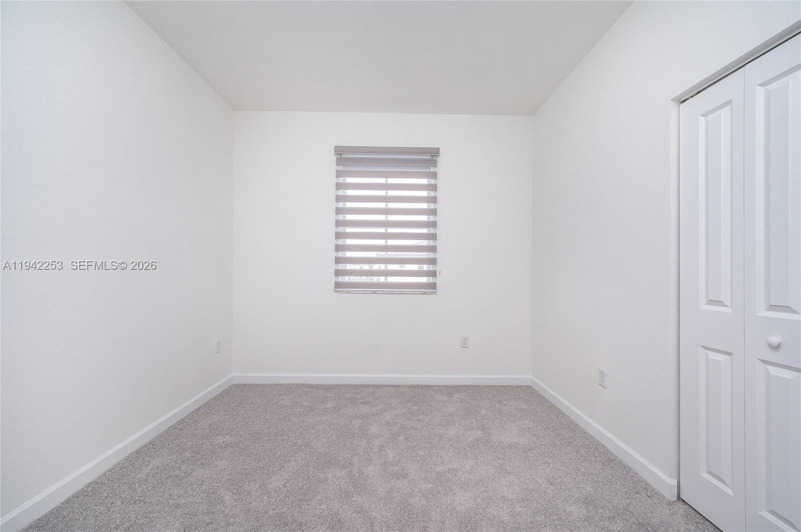 2747 Southeast 26th Road, Unit 2747 Homestead, FL 33035 - Photo 15 of 27 a view of an empty room with a window